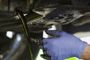 Changing the oil in a car.