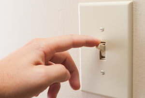 person flipping a light switch