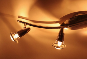 A modern lighting fixture casting shadows on the ceiling.