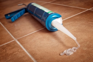 A tube of silicone glue in a caulking gun.