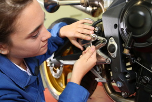 girl repairing motorcycle