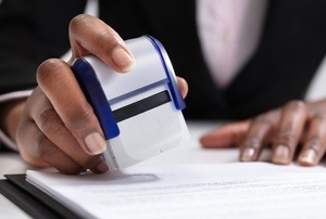 permit expediter stamping a document