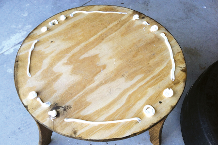 Center the tire on the bottom support, then use adhesive to secure the other pie