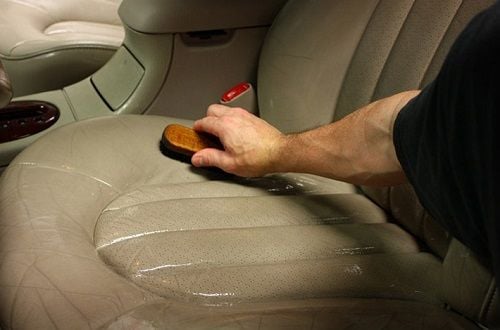 washing a leather car seat