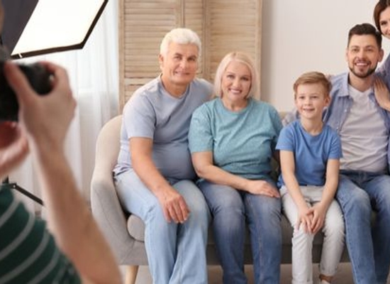 person shooting family photo of multiple generations