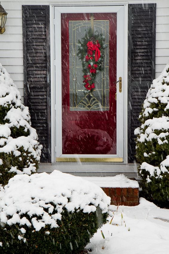 Storm door on a front door with snow all around
