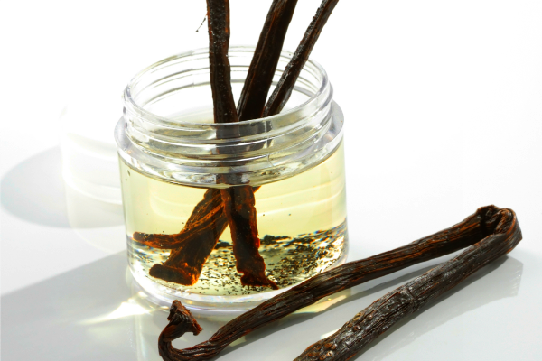 vanilla beans with a jar of liquid