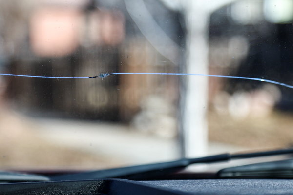 A crack in a car's windshield. 
