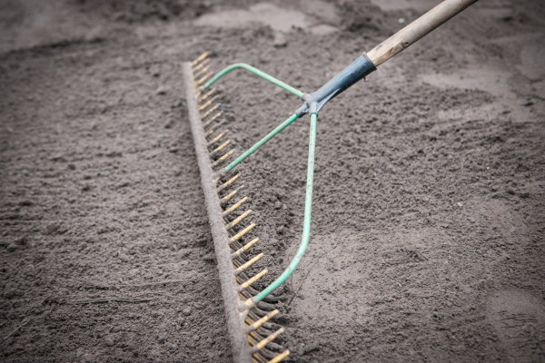 A rake pulling dirt