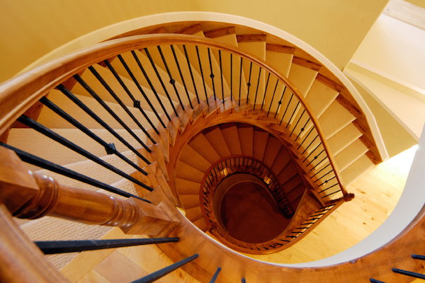 Wood stairs with a railing.