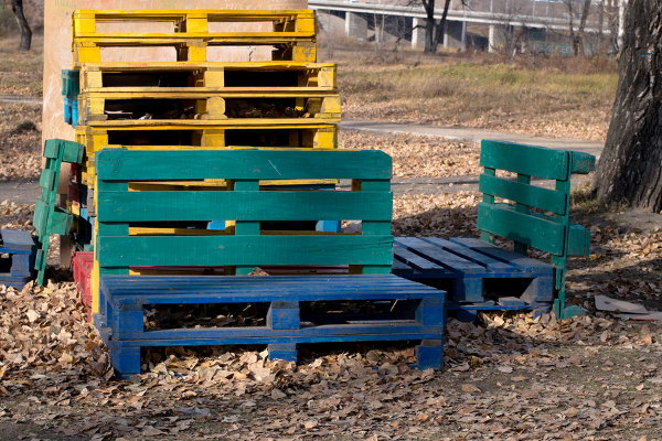 A stack of pallets and a pallet bench. 