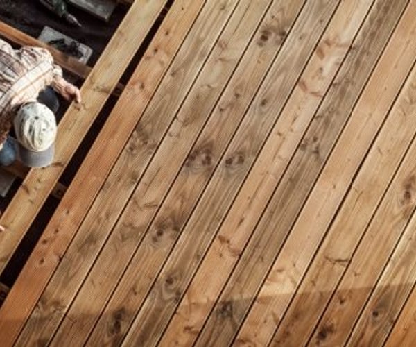 person building a wood deck