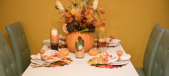 A Thanksgiving tablescape with a pumpkin vase.