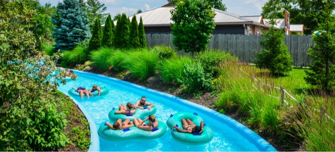people riding inner tubes on a lazy river swimming pool
