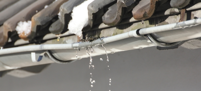 dripping gutter with freezing damage in winter
