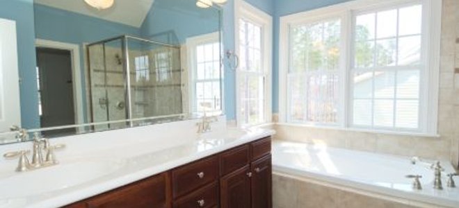 A view of a master bathroom vanity and tub set up.
