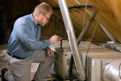 man inspecting a furnace