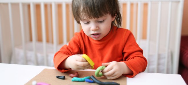 A child plays with Playdough.