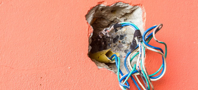 cluster of wires in a wall outlet hole