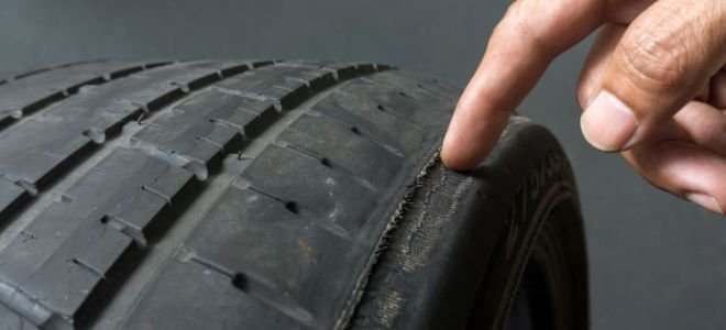 finger checking tire tread
