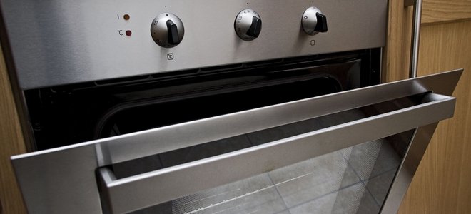 A built-in stove with the door ajar.