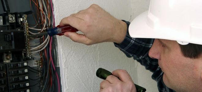 repairman working on a breaker box
