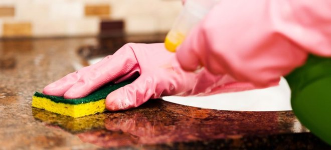wiping a counter with a sponge