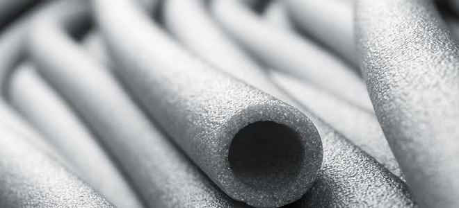 A close-up of gray foam pipe insulation.