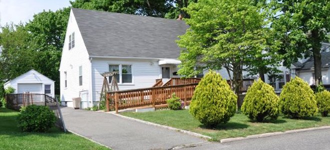 A house with a wood ramp leading to the front door.