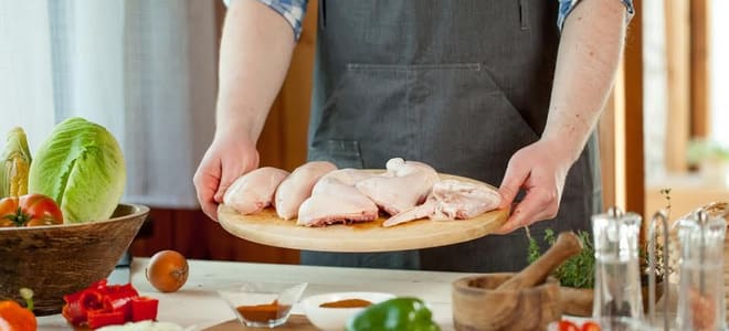 Raw chicken on a cutting board. 