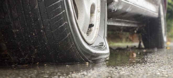 a flat tire on wet concrete