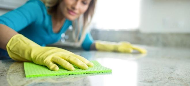 woman wiping down a countertop