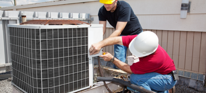 men working on an air conditioner