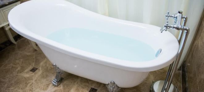 A claw foot bathtub in a fancy bathroom. 