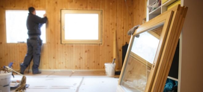 room under construction with wood paneling and glass windows