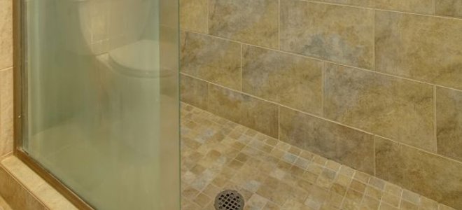 A shower with sliding glass doors.