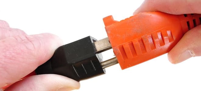 plugging a cord into an extension cord