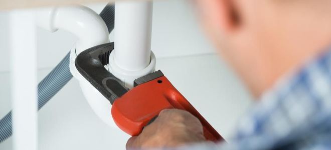 A plumber fixing a leak.