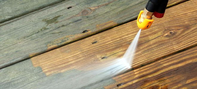 A power washer on a wood deck. 