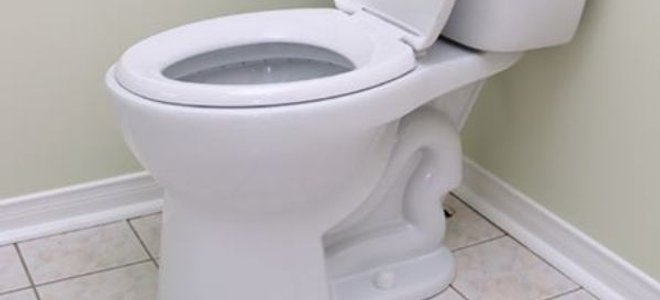 A white toilet on a vinyl floor