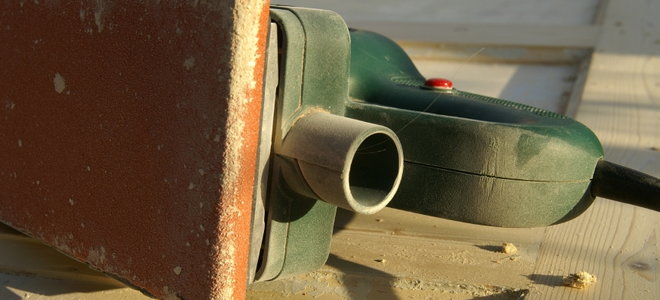 belt sander covered in sawdust