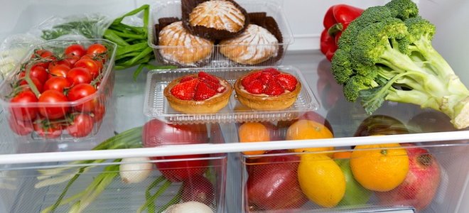 refrigerator with veggies and other foods inside
