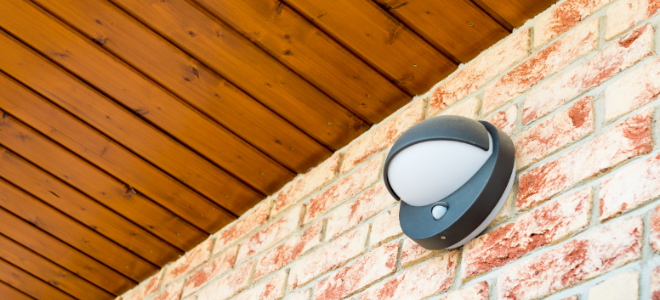 outdoor motion sensored light mounted to a brick wall