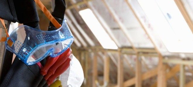 man with tools in an attic
