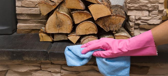 A person cleans a wood storage area.