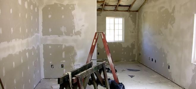 Room with drywall, tape, and mud on walls.