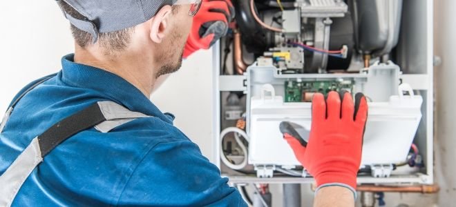 Repairman looking at a furnace