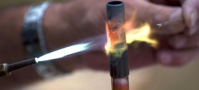 Metalworking with a soldering torch.