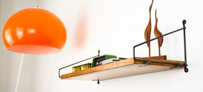 Decorative wall shelf with orange light globe nearby