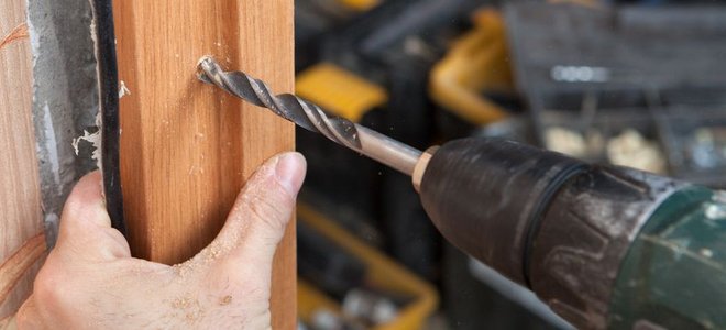 Drilling through a door jamb into a frame.